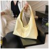 8b2e01dd-65f9-423b-86ef-ebacf0ae265a_trans Minimalist, versatile handbag with a unique, niche appeal